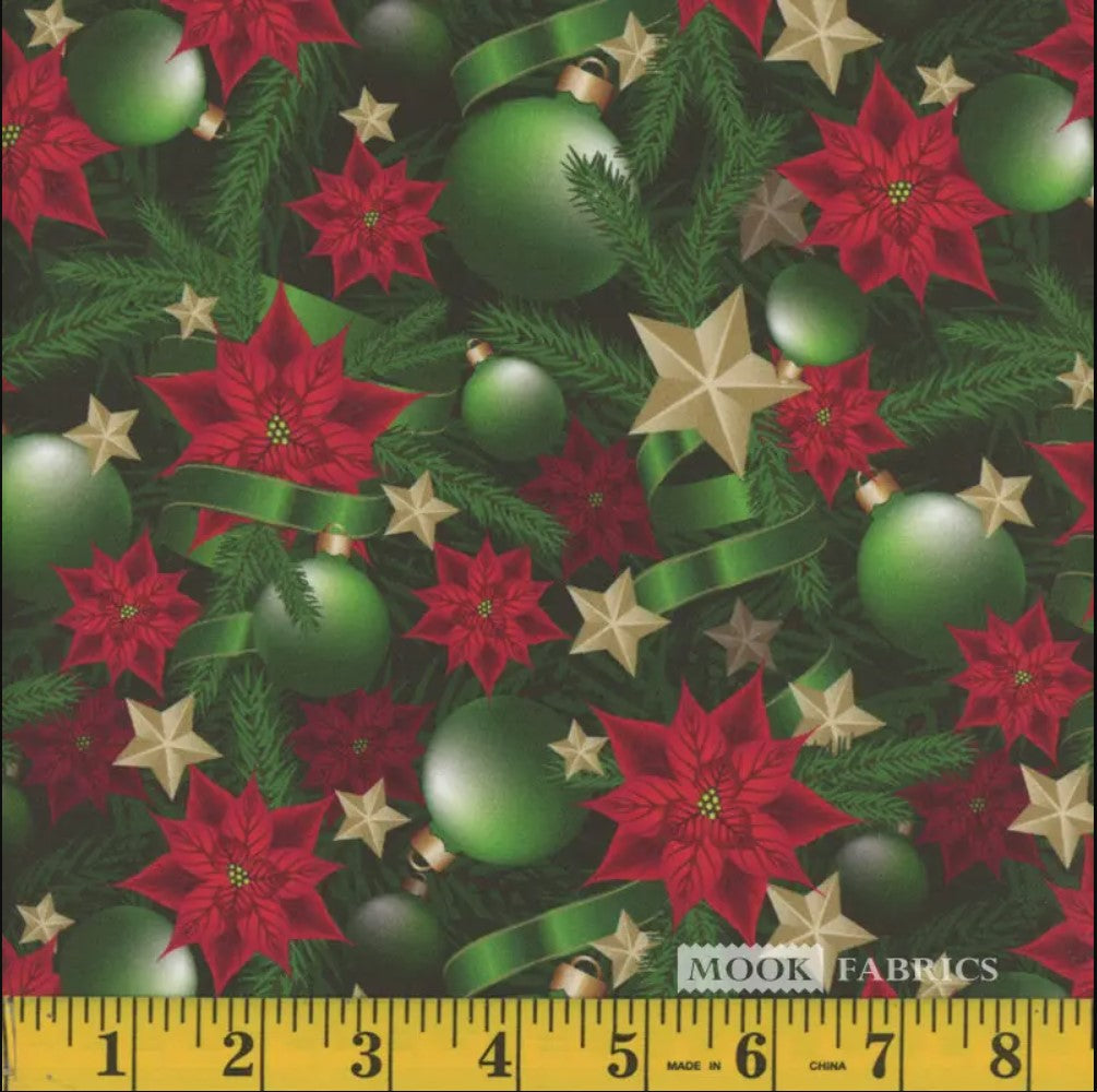 A yardstick measuring the width of fabric featuring Christmas-themed patterns including green ornaments and ribbons with gold stars and red poinsettias.