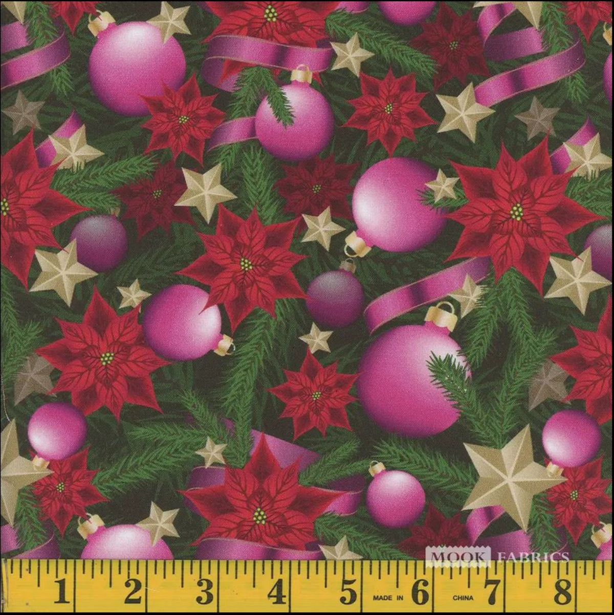 A yard of pink cotton fabric with a Christmas pattern featuring silver stars and red poinsettias, displayed alongside a measuring ruler.