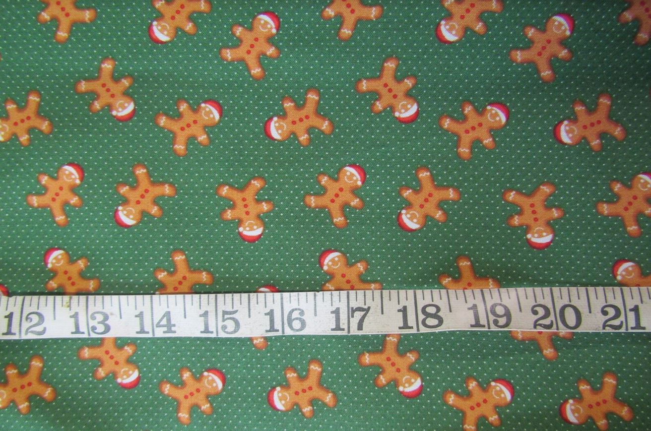Christmas Fabric Happy Gingerbread Men with Santa Hats on Dotted Green Dots by the yard