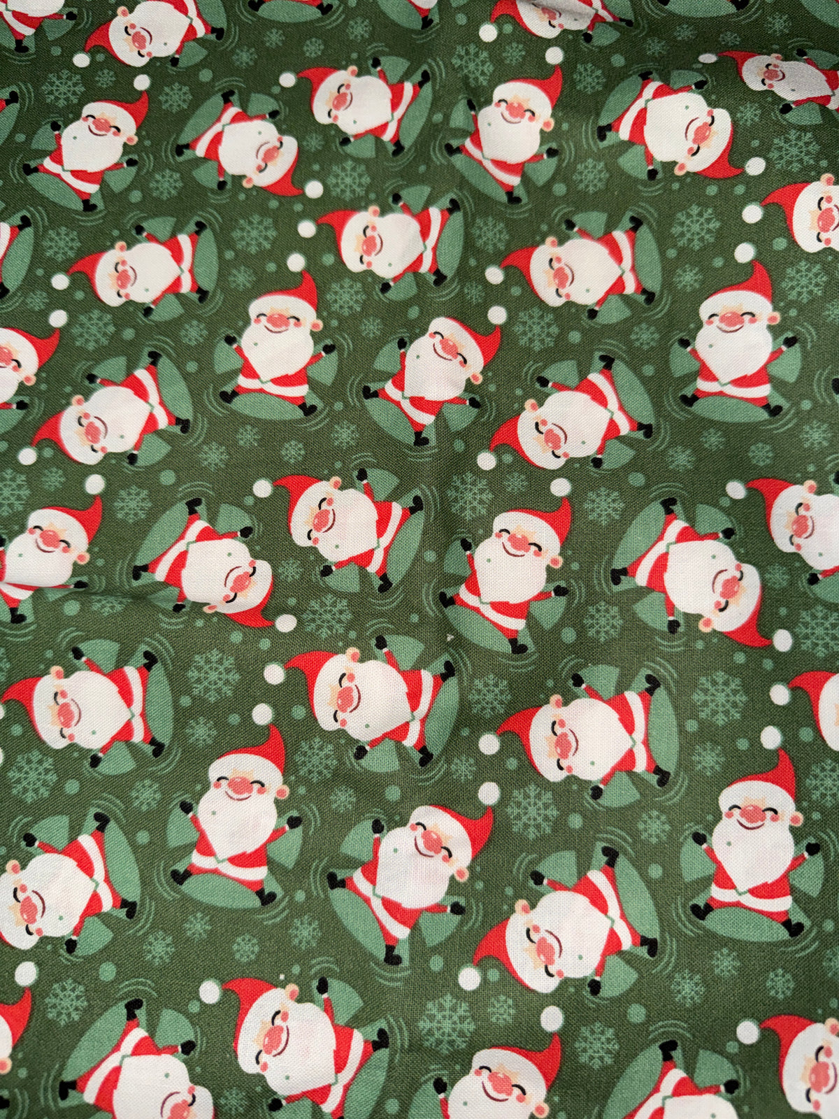 Christmas Santa making Snow Angels on Green 100% Cotton Fabric